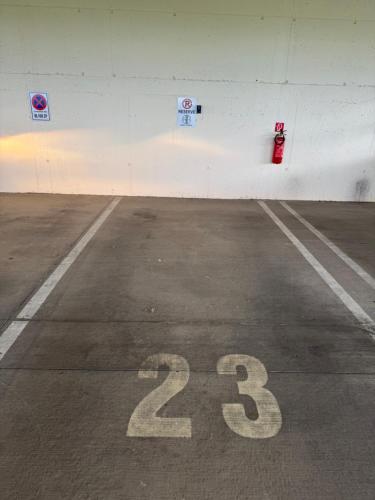 a parking lot with a red fire hydrant on a wall at Harley Quinn Apartment in Poprad