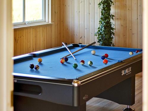 a pool table with balls and cues on it at Luxury Pool Retreat in Nordborg - By Traum Ferienwohnungen in Nordborg