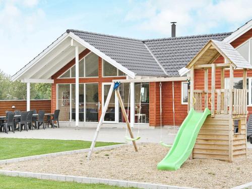 a house with a playground in front of it at Luxury Pool Retreat in Nordborg - By Traum Ferienwohnungen in Nordborg