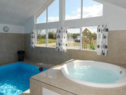 a large bathroom with a tub and a large window at Luxury Pool Retreat in Nordborg - By Traum Ferienwohnungen in Nordborg