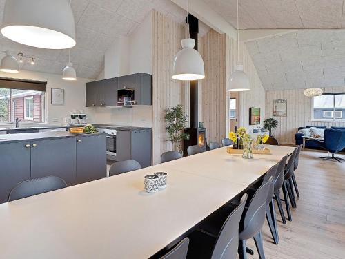 a kitchen and dining room with a large table and chairs at Luxury Retreat with Pool - By Traum Ferienwohnungen in Grenå