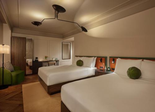 a hotel room with two beds and a chair at Sixty DC in Washington