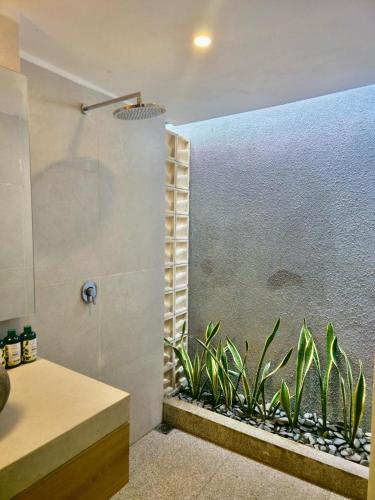 a bathroom with a shower with plants in it at PARAWIYA Villa in Munduk