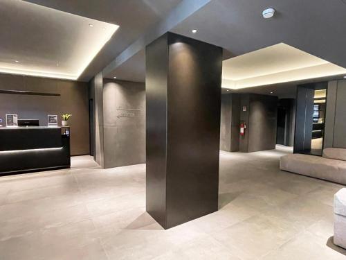 a lobby of a building with a reception desk at Scarlatti Hotel Milano in Milan