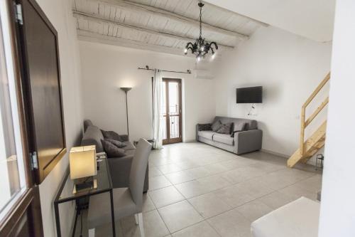 a living room with a couch and a tv at B&B del Massimo in Palermo