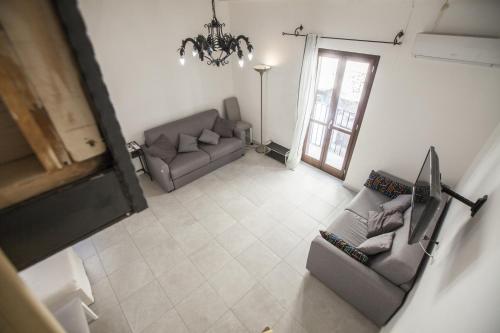 a living room with two couches and a chandelier at B&B del Massimo in Palermo