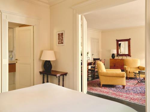 a bedroom with a bed and a living room at Hotel la Ponche in Saint-Tropez
