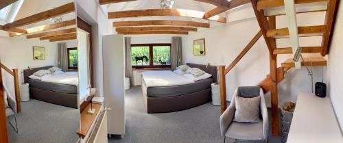 a small room with two beds and a staircase at Ferienhaus in Rostock - Brinckmansdorf in Rostock