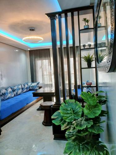 a living room with a couch and a blue bed at Beachside Apartment in Mohammedia