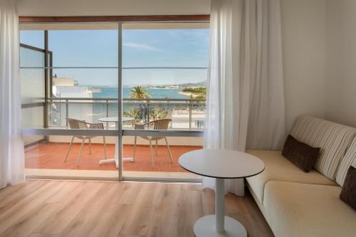 a living room with a couch and a view of the ocean at Sol Marbella Estepona Atalaya Park in Estepona