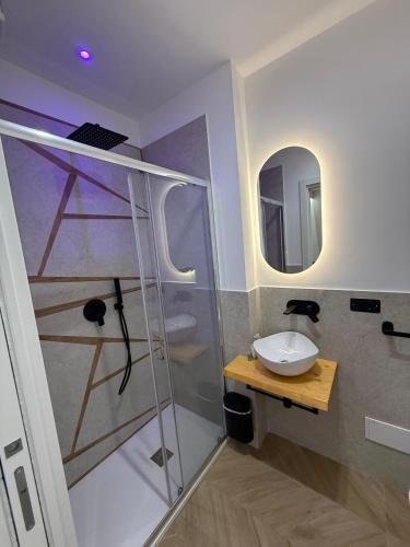 a bathroom with a glass shower and a sink at Ulivo Guest House Roma in Rome
