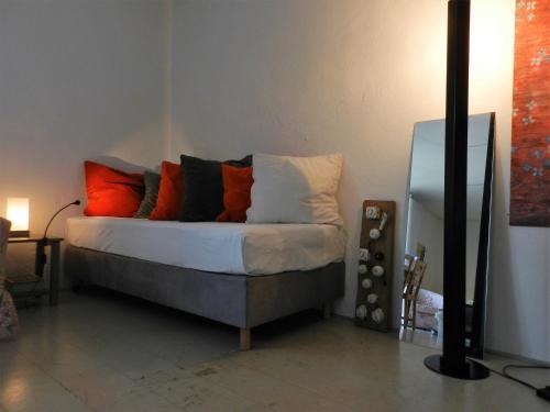 a bed with colorful pillows on it in a room at Blue Wall BnB in Gebenstorf