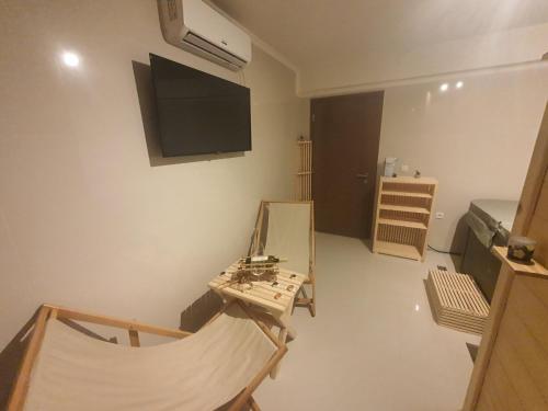 a living room with a tv on the wall at Planinska Kraljica in Gornje Pale