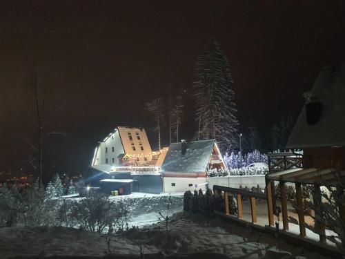 a building in the snow at night at Planinska Kraljica in Gornje Pale