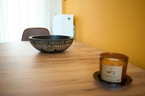 a bowl and a cup on a wooden table at Skye urban oasis in Tripolis