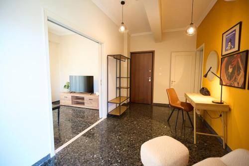 a room with a desk and a television and a mirror at Skye urban oasis in Tripolis