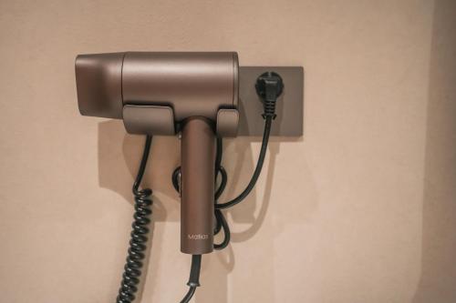a phone is hanging on a wall at Modern Space Hotel-Guangzhou Nansha Wanda Plaza near Line4 STN&Line18 STN in Guangzhou