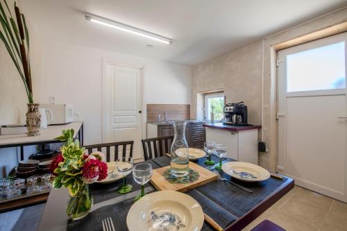 a kitchen and dining room with a table with wine glasses at Yourte mongole insolite en pleine nature in Pouilly-sous-Charlieu