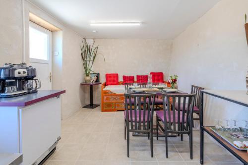 a kitchen and living room with a table and chairs at Yourte mongole insolite en pleine nature in Pouilly-sous-Charlieu