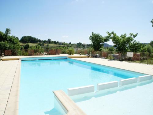 a large swimming pool with blue water at Relaxing Family Stay in Les Vans in Chambonas