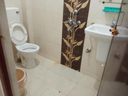 a bathroom with a toilet and a sink at Ghosh homestay 8 in kolkata