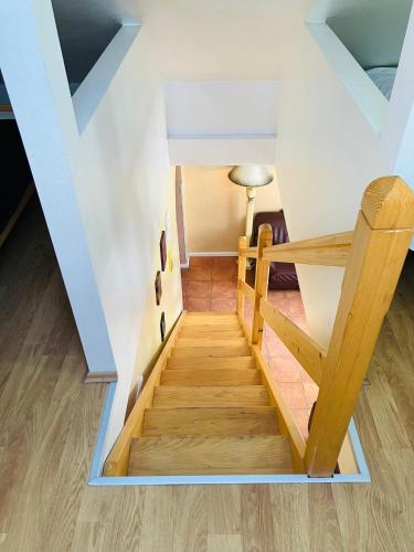 a staircase in a house with wooden floors at Lovely Garden 100m2 apartment in Novi Sad