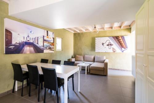 a dining room with a table and chairs and a couch at Lozer Lodge Vakantiewoning in Kruisem