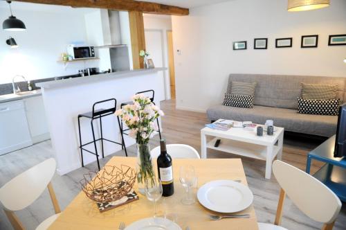 a living room with a table with a vase of flowers on it at maison garroenea in Sare