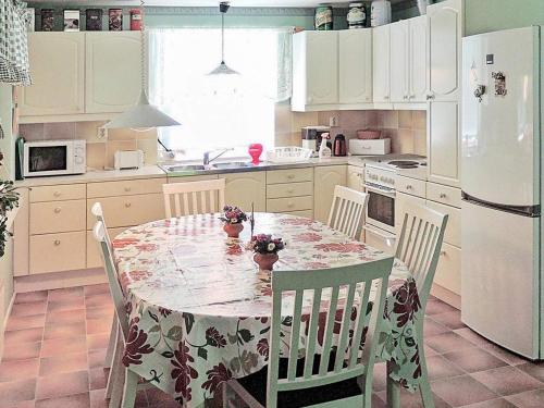 a kitchen with a table and chairs and a white refrigerator at 6 person holiday home in HÄSTVEDA-By Traum in Hästveda