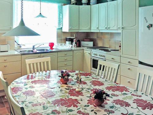 a kitchen with a table with a flowered table cloth at 6 person holiday home in HÄSTVEDA-By Traum in Hästveda