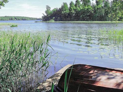 a boat sitting on the side of a lake at 6 person holiday home in HÄSTVEDA-By Traum in Hästveda