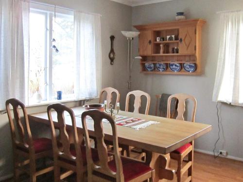 a dining room with a wooden table and chairs at 6 person holiday home in Storsteinnes in Storsteinnes