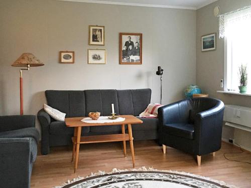 a living room with a couch and a table at 6 person holiday home in Storsteinnes in Storsteinnes