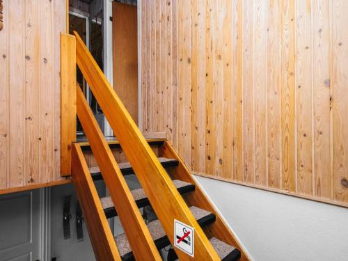 a wooden staircase in a room with wooden walls at Tranquil Haven in Ansager - By Traum Ferienwohnungen in Ansager