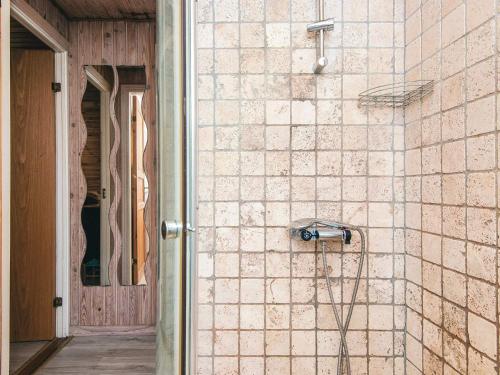 a shower in a room with a tiled wall at Tranquil Haven in Ansager - By Traum Ferienwohnungen in Ansager