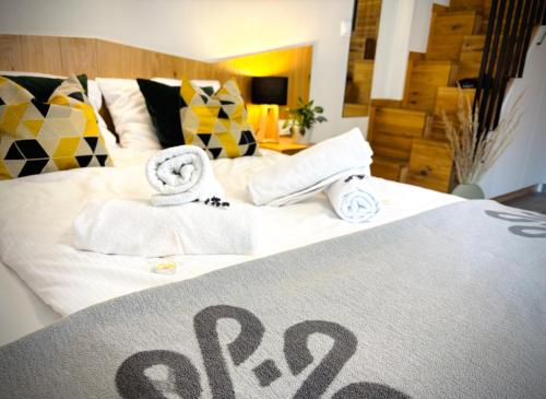 a bed with towels and a sign that says spa at Aparthotel Pod Stokiem z sauną i jacuzzi - szczyrkapartamenty in Szczyrk