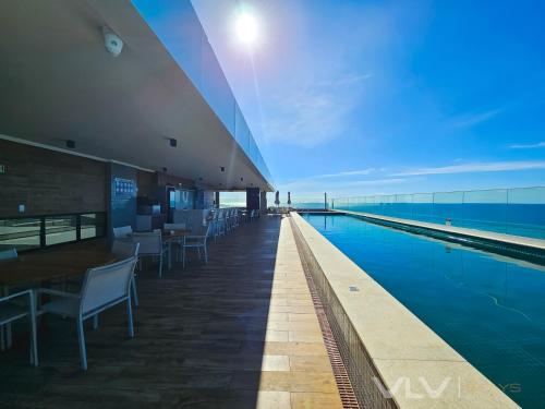 a swimming pool on the roof of a building at Residencial Premium Stella Maris by VLV Stays in Salvador