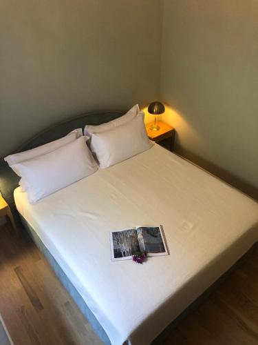 a bedroom with a bed with a book on it at Villa Mabel Boutique Hotel in Taormina