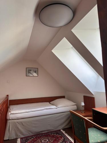 a bedroom with a bed in the attic at Apartman Reduta in Lučenec