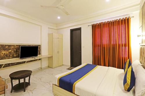 a hotel room with a bed and a television at Hotel Almora BY The ELEVATE Group Near Delhi INTERNATIONAL Airport WIth- Free AIRPORT Pickup in New Delhi