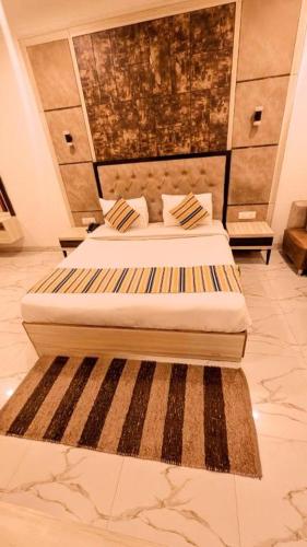a bedroom with two beds and a rug at Hotel Almora BY The ELEVATE Group Near Delhi INTERNATIONAL Airport WIth- Free AIRPORT Pickup in New Delhi