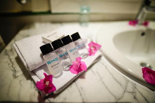 a bathroom counter with a sink and some complimentary cosmetics at Blumar Resort & Spa in Hammamet