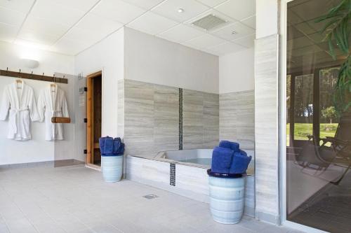 a bathroom with a tub and a large window at Downe Cottages in Hartland