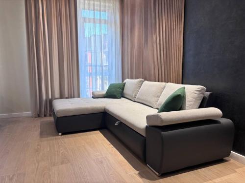 a couch in a living room with a window at Апартаменти біля моря in Odesa