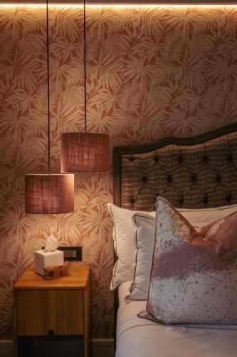 Katil atau katil-katil dalam bilik di Le Petit Manoir Boutique Hotel
