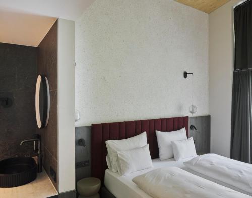 a hotel room with a bed and a bathroom at Neueröffnung ELVA PREMIUM APARTMENT HOTEL inklusive Sommerpass STUBAI SUPER CARD in Neustift im Stubaital