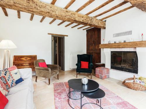 a living room with a couch and a fireplace at Holiday Home Dunes with Private Pool in Dunes