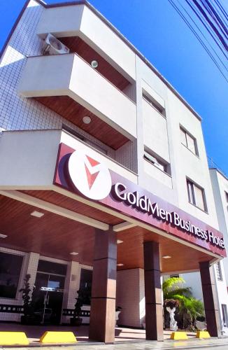 a building with a global investment firm sign on it at Goldmen Business Criciúma in Criciúma