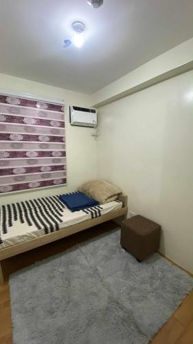 a small room with a bed and a window at Budget-friendly Unit in Davao City