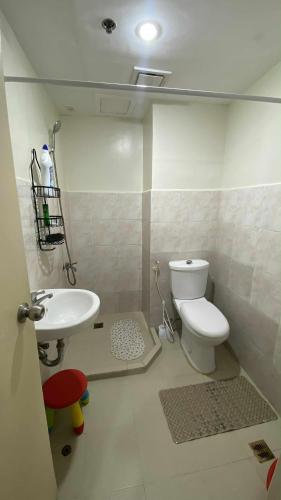 a bathroom with a toilet and a sink at Budget-friendly Unit in Davao City